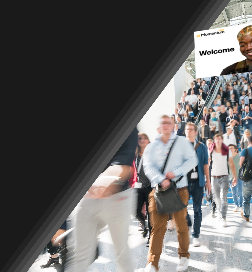 conference attendees descending escalators in event venue.